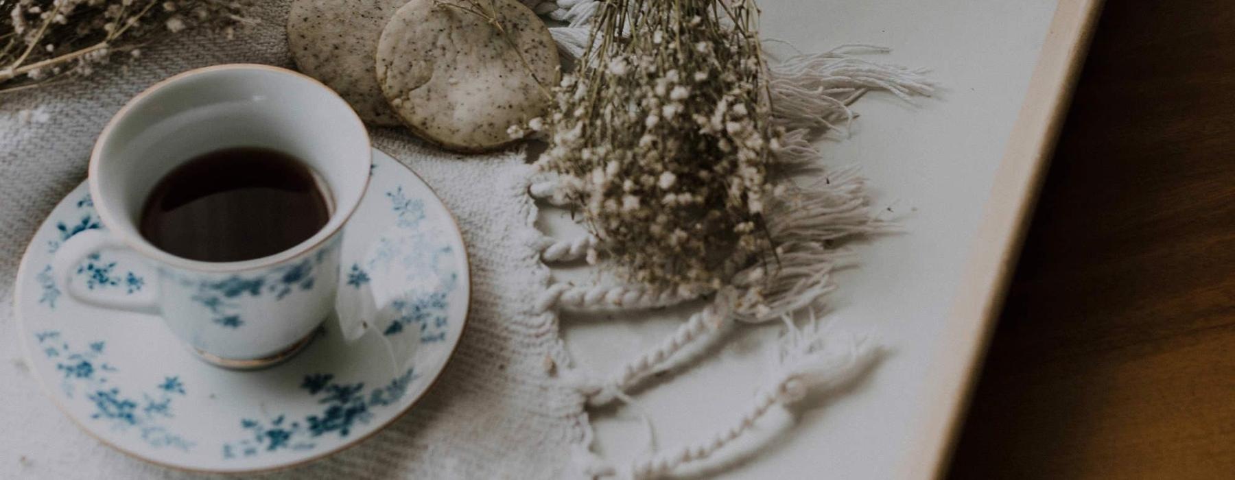 tea and cookies on a serving tray with baby's breath