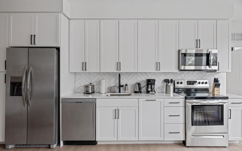 a kitchen with white cabinets